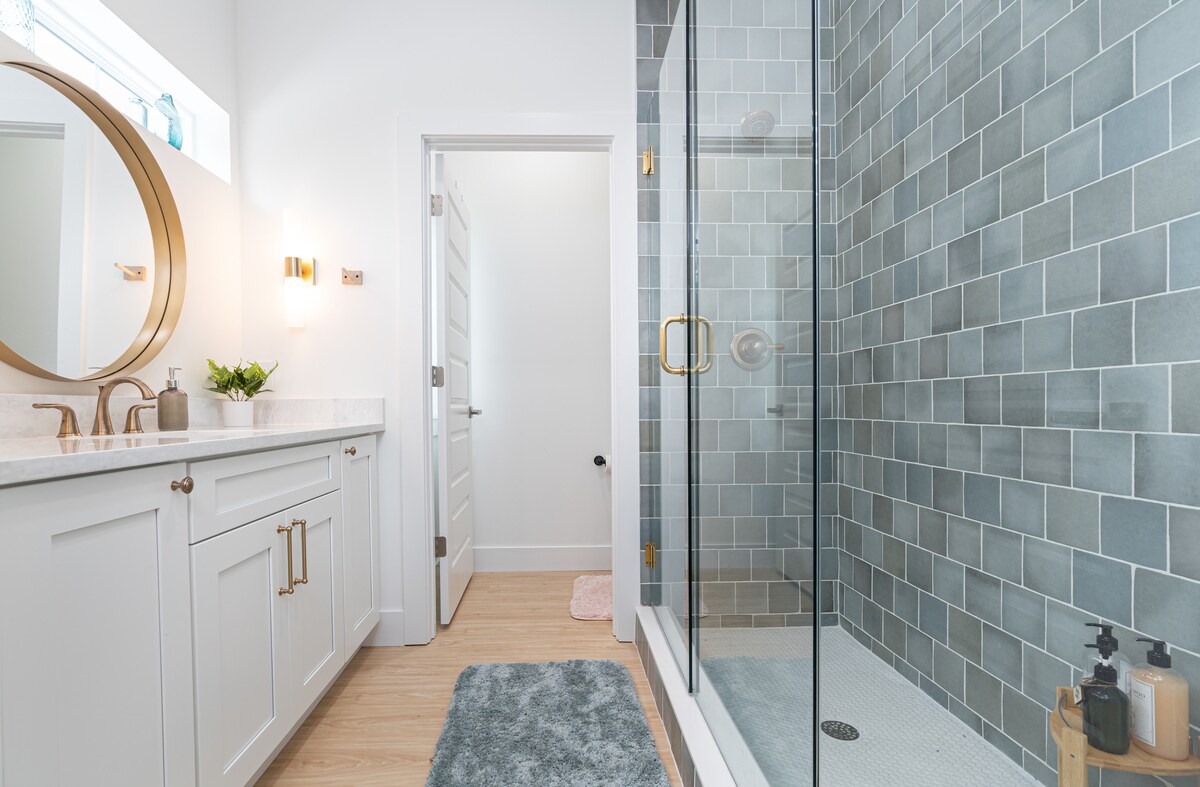 A separate water closet sits behind that door, so the shower and the sink stay free while somebody else is getting ready. It is a small piece of design that quietly saves a great deal of morning negotiation.