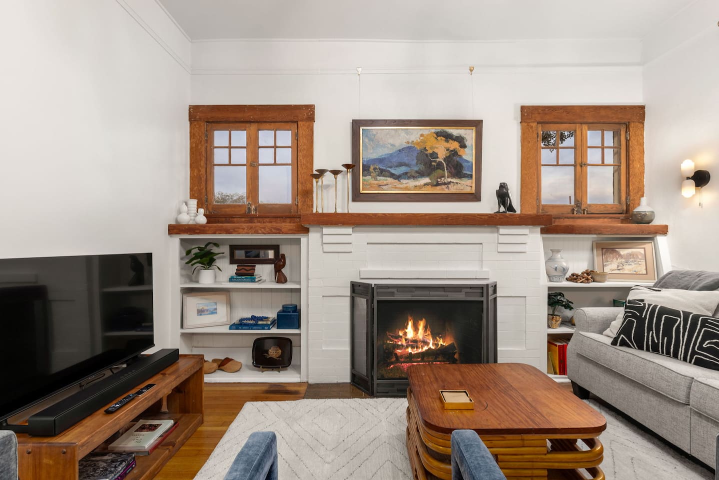 cozy living room with decorative fireplace and new TV