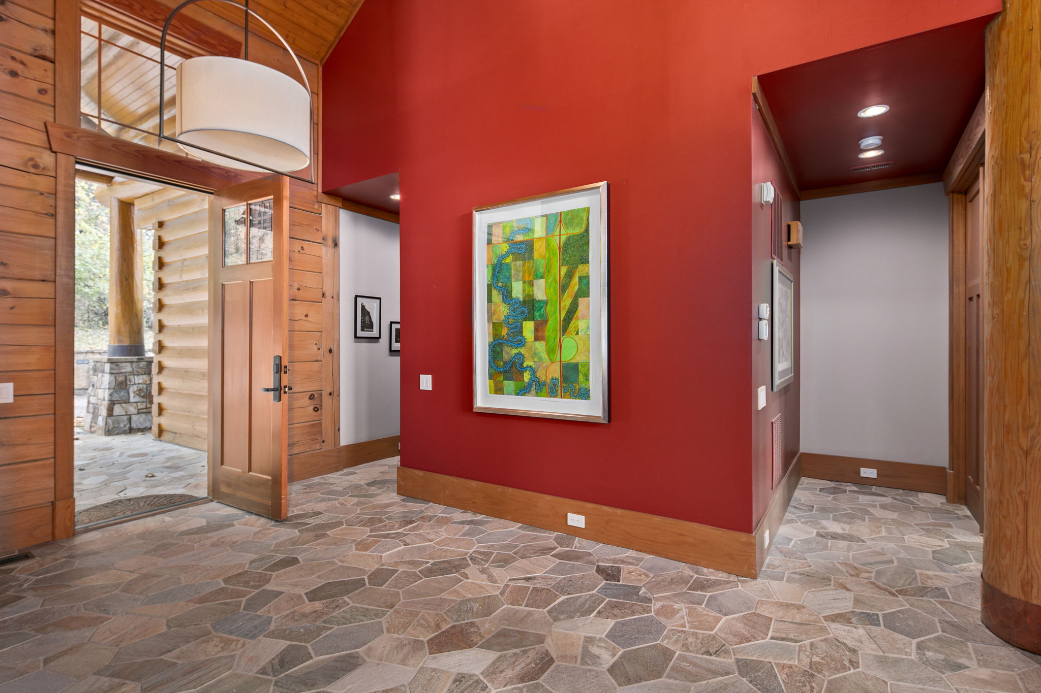 Grand entry way, vibrant colors, modern trim with warm feel all around