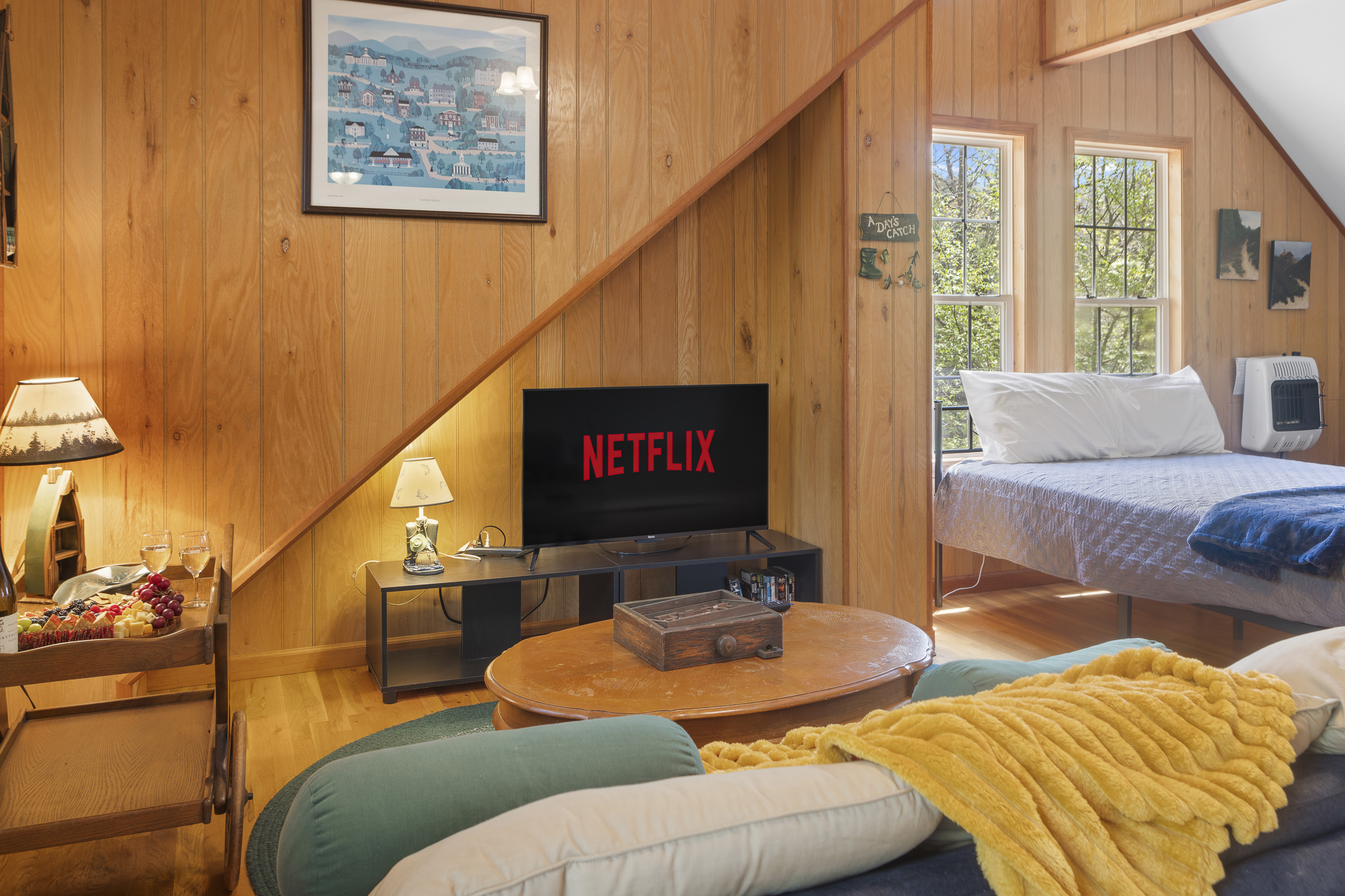 Cottage Living Area: Enjoy movie nights with a warm atmosphere and stunning views from your retreat!
