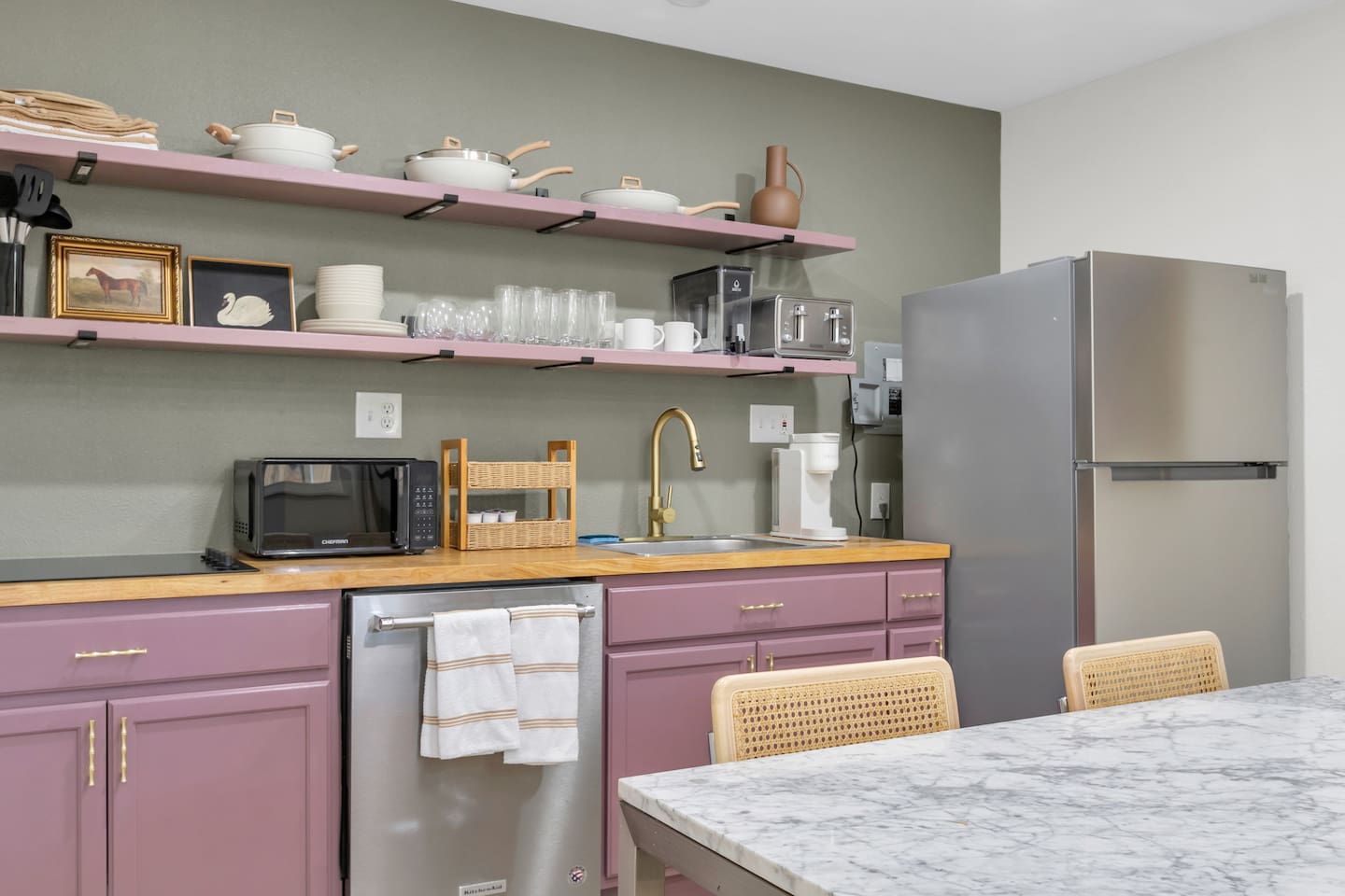 Enjoy the convenience of a fully equipped kitchen complete with a full size refrigerator and freezer, 4-burner electric stove, microwave, Keurig, and all the kitchenware needed for home-cooked meals.