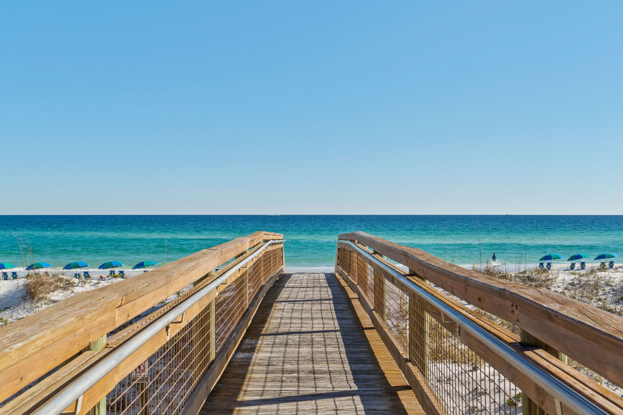 Your private path to paradise! 👣 Follow this scenic wooden walkway through the dunes and straight to the emerald waters. It’s a peaceful, breezy stroll that makes every beach day feel like a true escape.