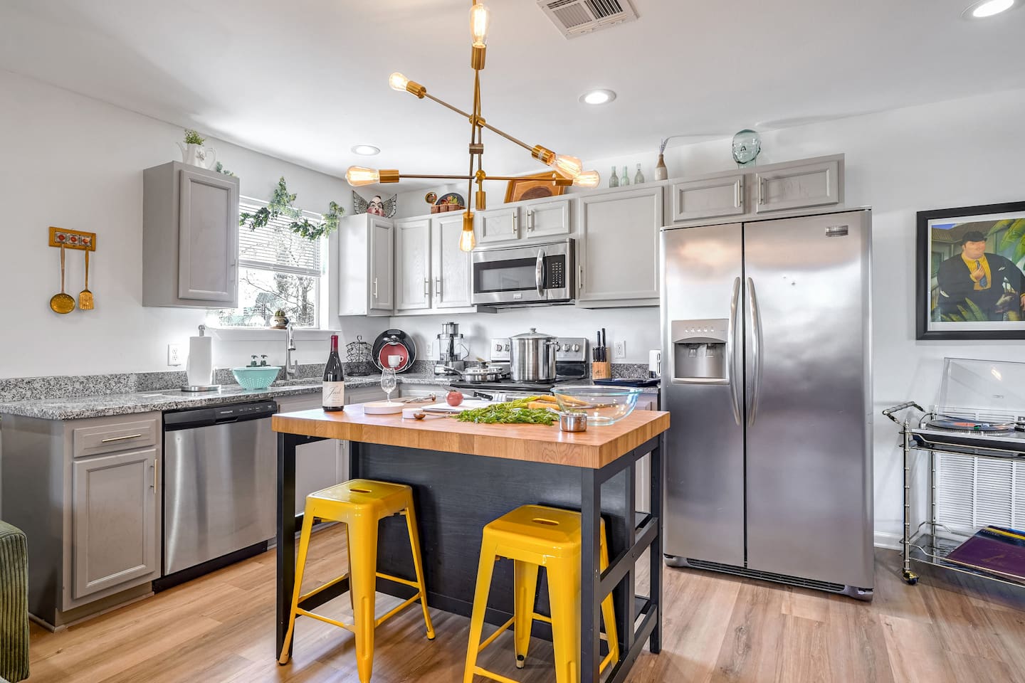 Fully equipped kitchen with a dishwasher, coffee (ground & pods), creamer, and sugar, filtered water, paper towels, and dishwasher pods. 