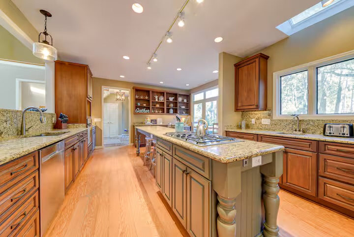 Kitchen features a large island to gather around with tons of natural light