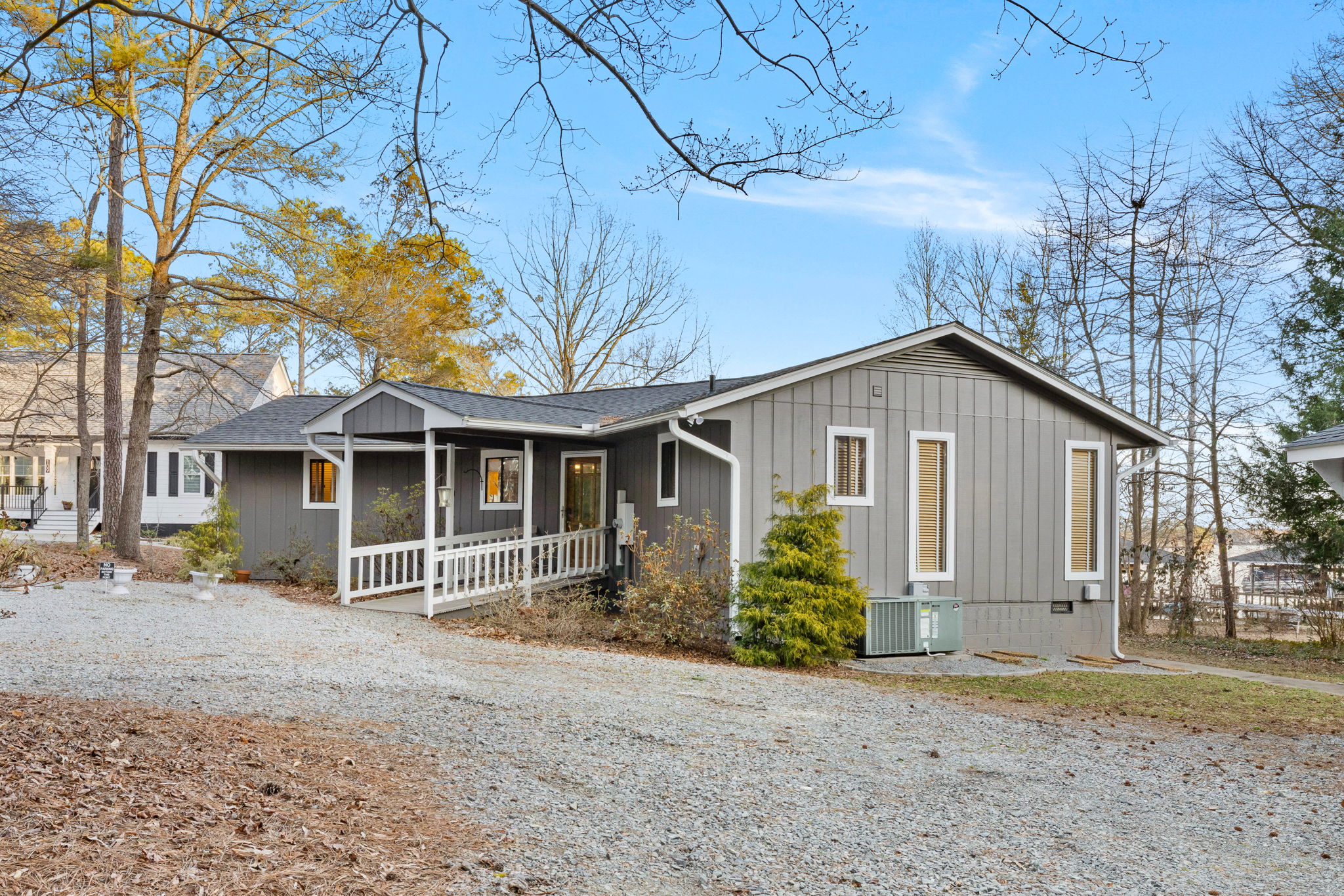 Charming Exterior: Embrace lakeside tranquility in this inviting retreat surrounded by nature!