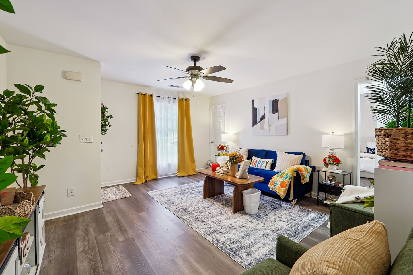 The living room features cozy furniture, including a comfortable blue couch, and an Amazon Fire-powered Smart TV for your entertainment. You’ll also find the Xfinity modem conveniently located here, convenient for ethernet connection.