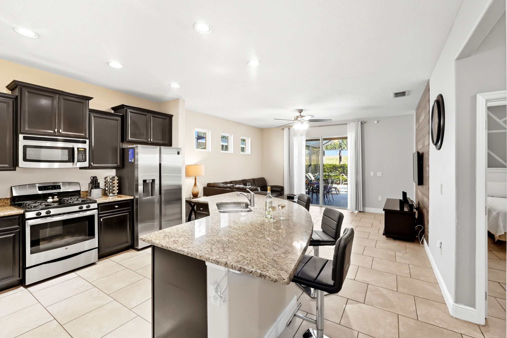 Kitchen to living room to sliders that lead to pool.