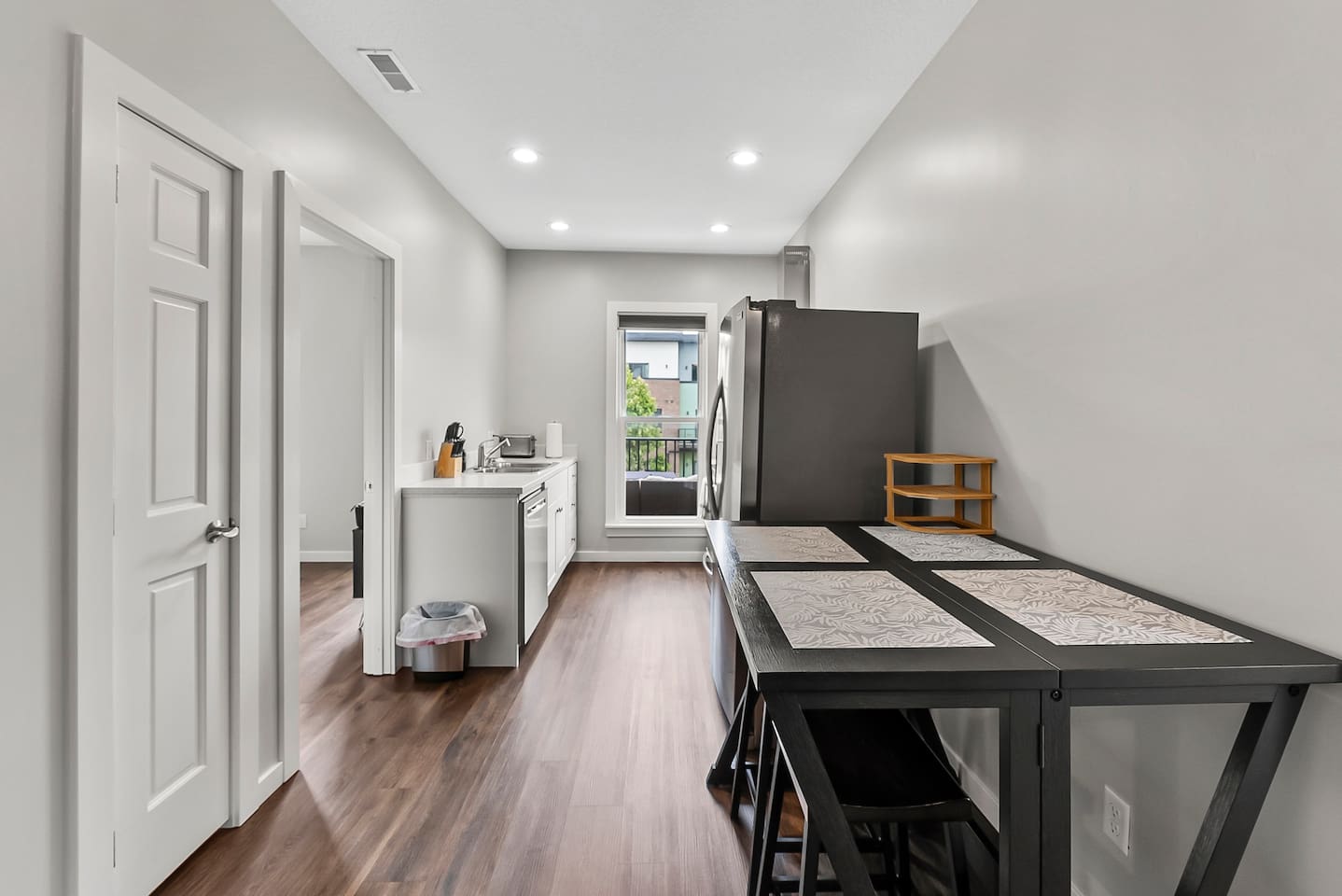 Minimalist dining corner that complements the kitchen and living area for easy flow and comfort.