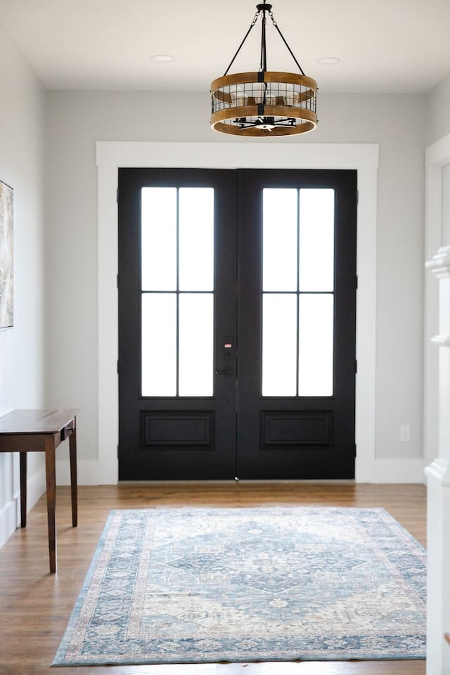 Welcome! Our large double front doors open toward the grand staircase and open living room/kitchen area, with the library/music room on the right when you enter. 