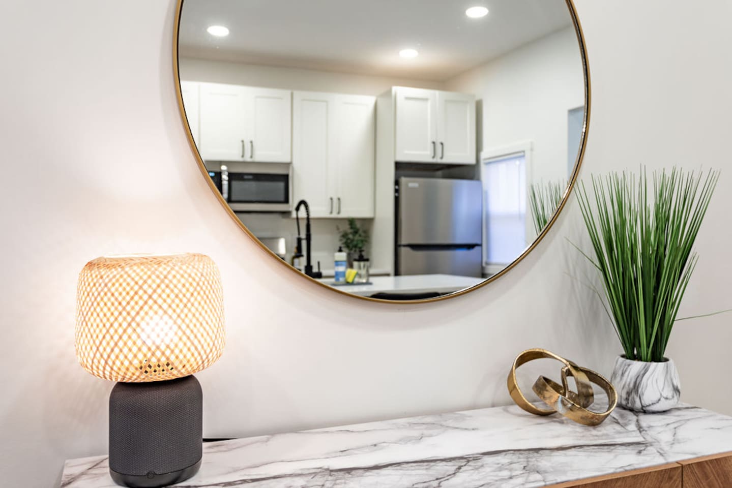 Stylish circular mirror on the back wall of the kitchen, adding a modern touch to the space.