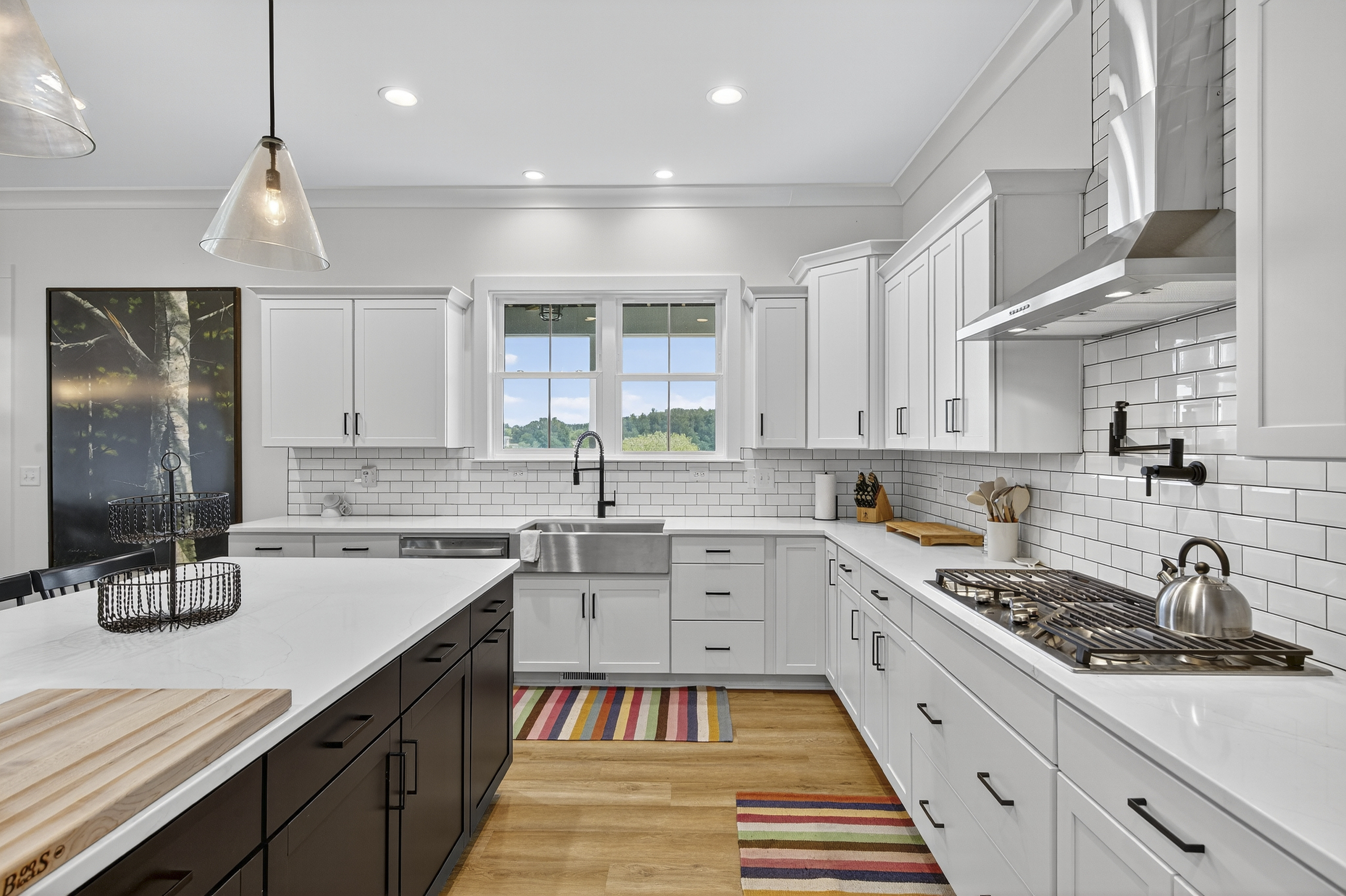 Cook like a chef in this fully equipped kitchen featuring a large center island, gas cooktop, and double ovens.