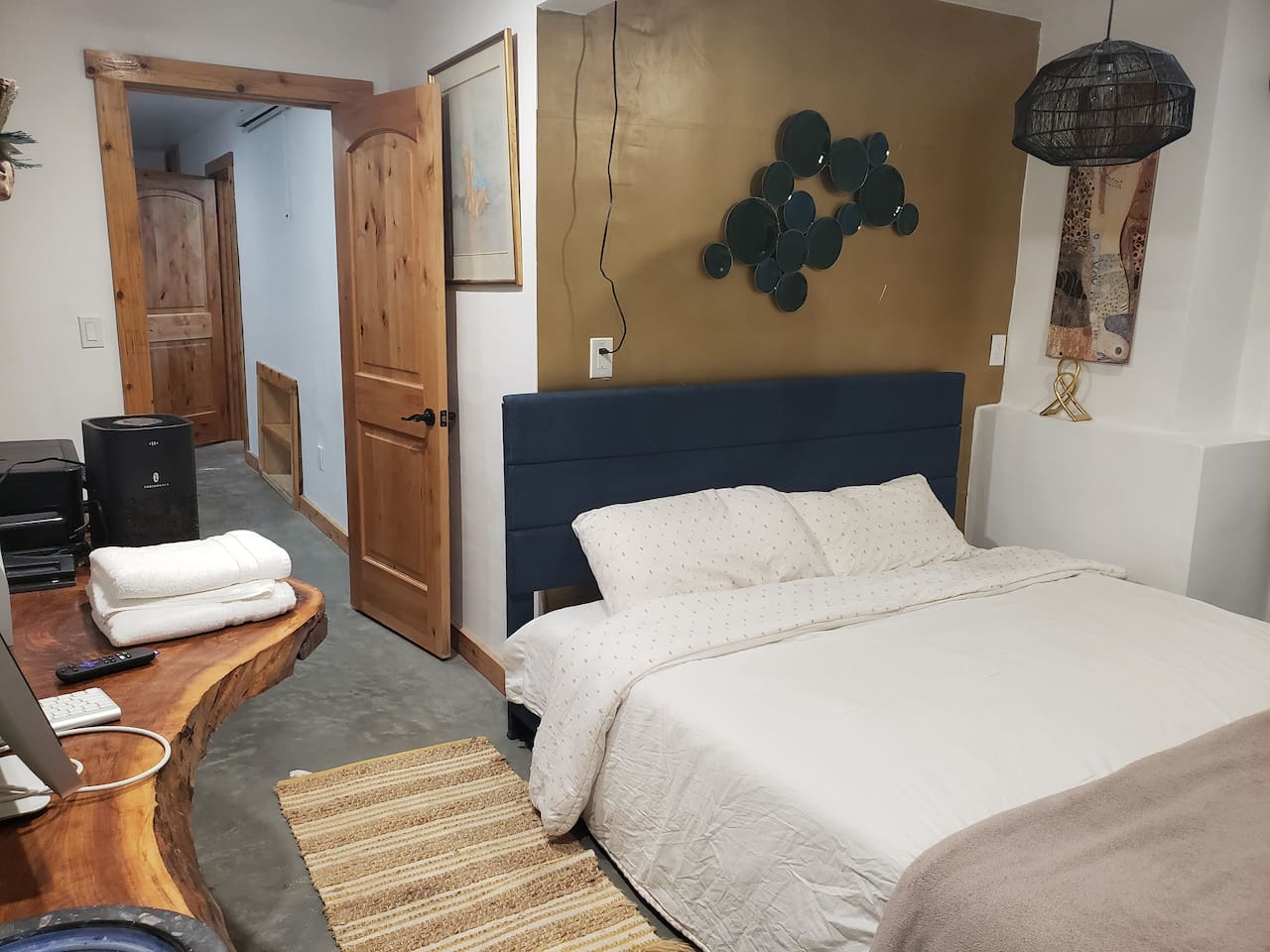 Bedroom 6 with sliding door walkout access from basement and ensuite bathroom. Live edge desk. 