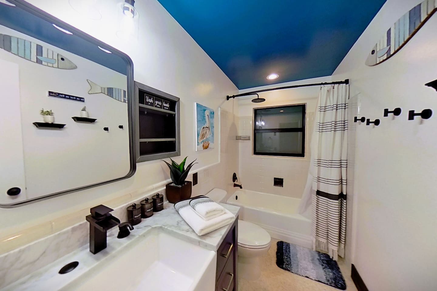 Bathroom with Modern Farmhouse Sink, Rain Shower Head and Plenty of Shelves and Storage for all you need to bring. We provide Oversized Towels, Washcloths', Hand Towels and Makeup Removal Towels. Qtips, Cotton Balls & Swabs, Shampoo, Conditioner