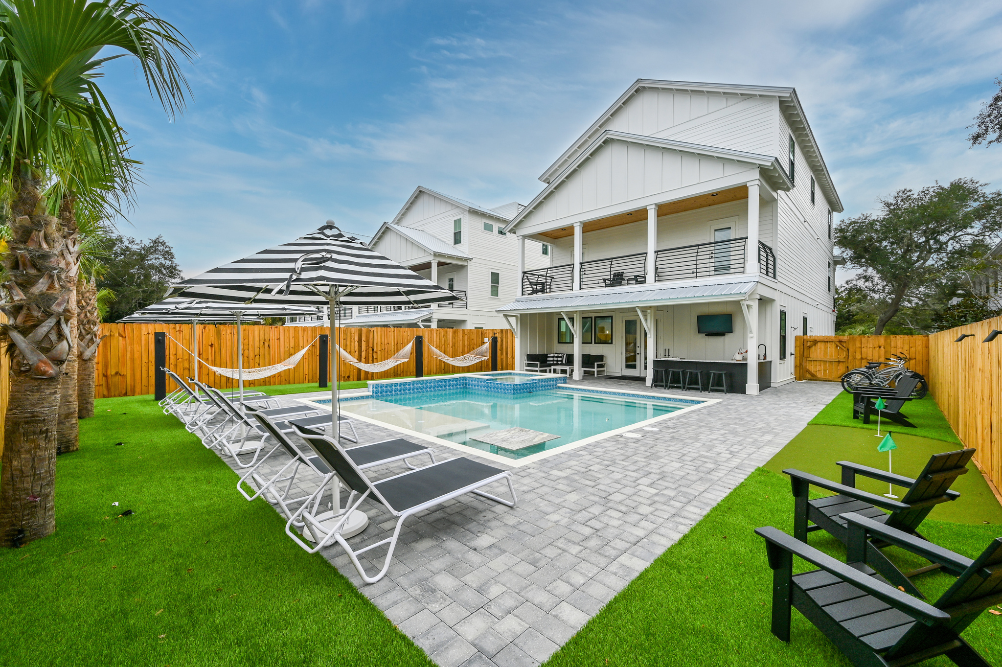 Satisfying Astroturf with luxury lounges, matching umbrellas, poolside hammocks, and putting green.
