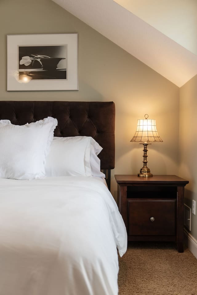 Stylish bedside table with a lamp, providing both convenience and ambiance for your nighttime reading or relaxation.