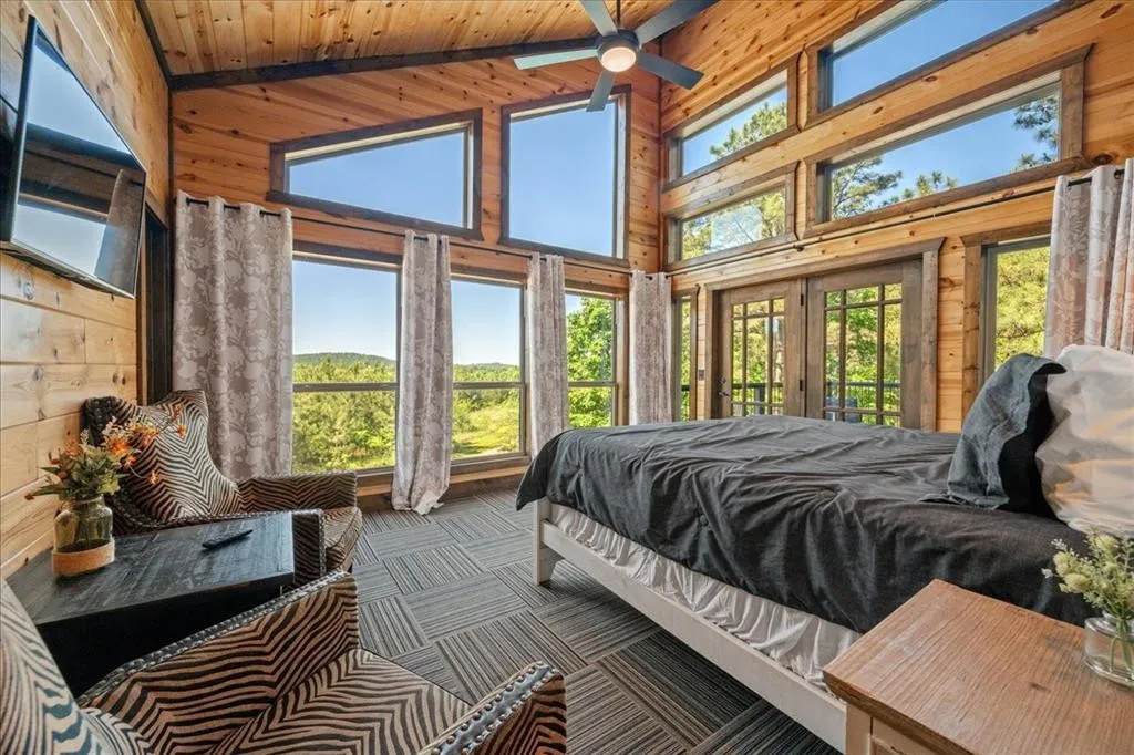 Master bedroom with king bed, smart TV, balcony and mountain views.
