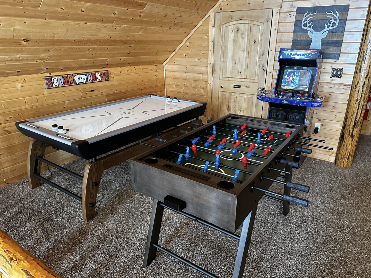 Upstairs game area w/ air hockey, foosball table, and arcade