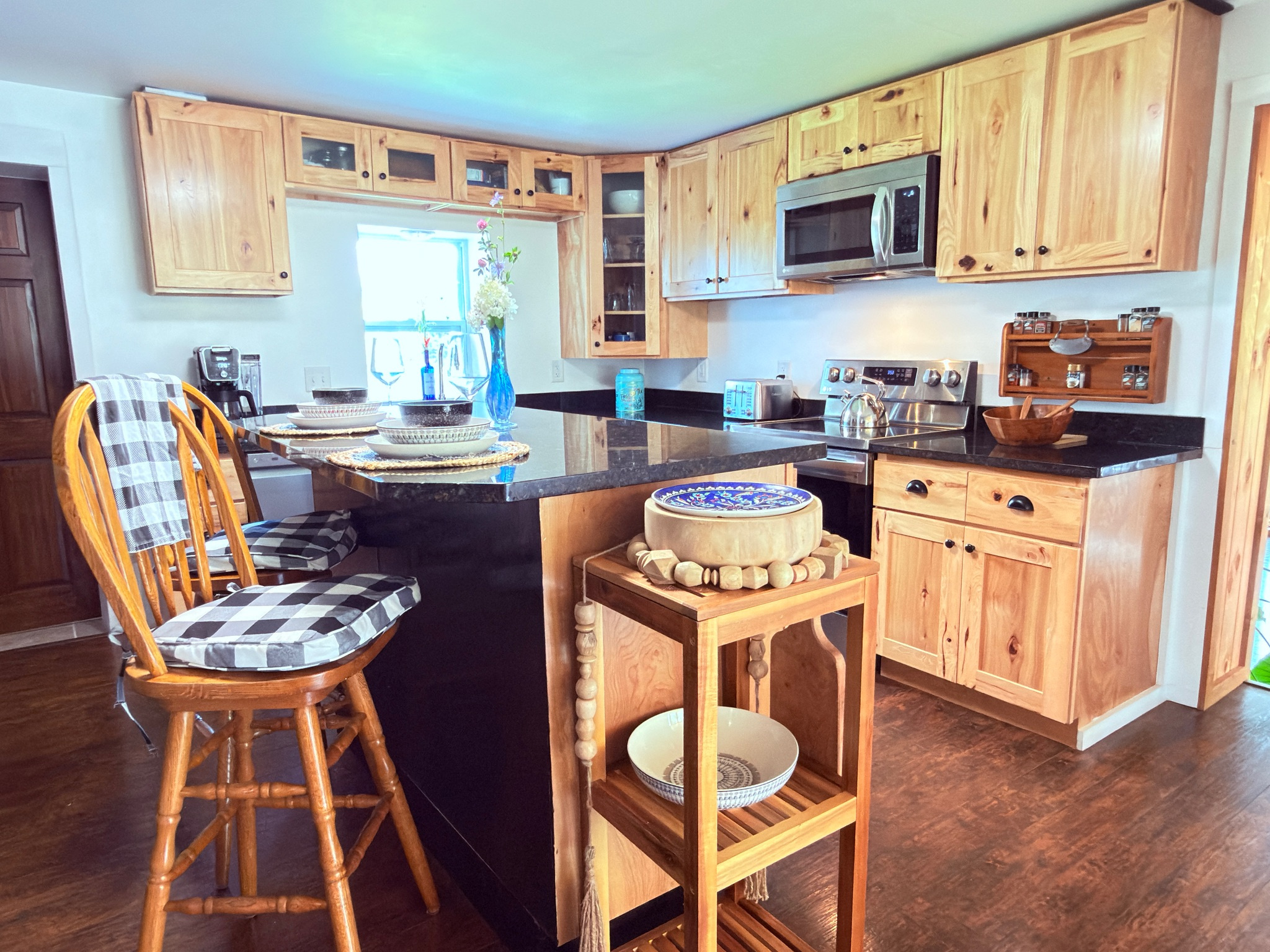 Kitchen view featuring our spacious granite island, garden window, and extensive spice collection. A bright, functional space perfect for preparing meals during your stay. 