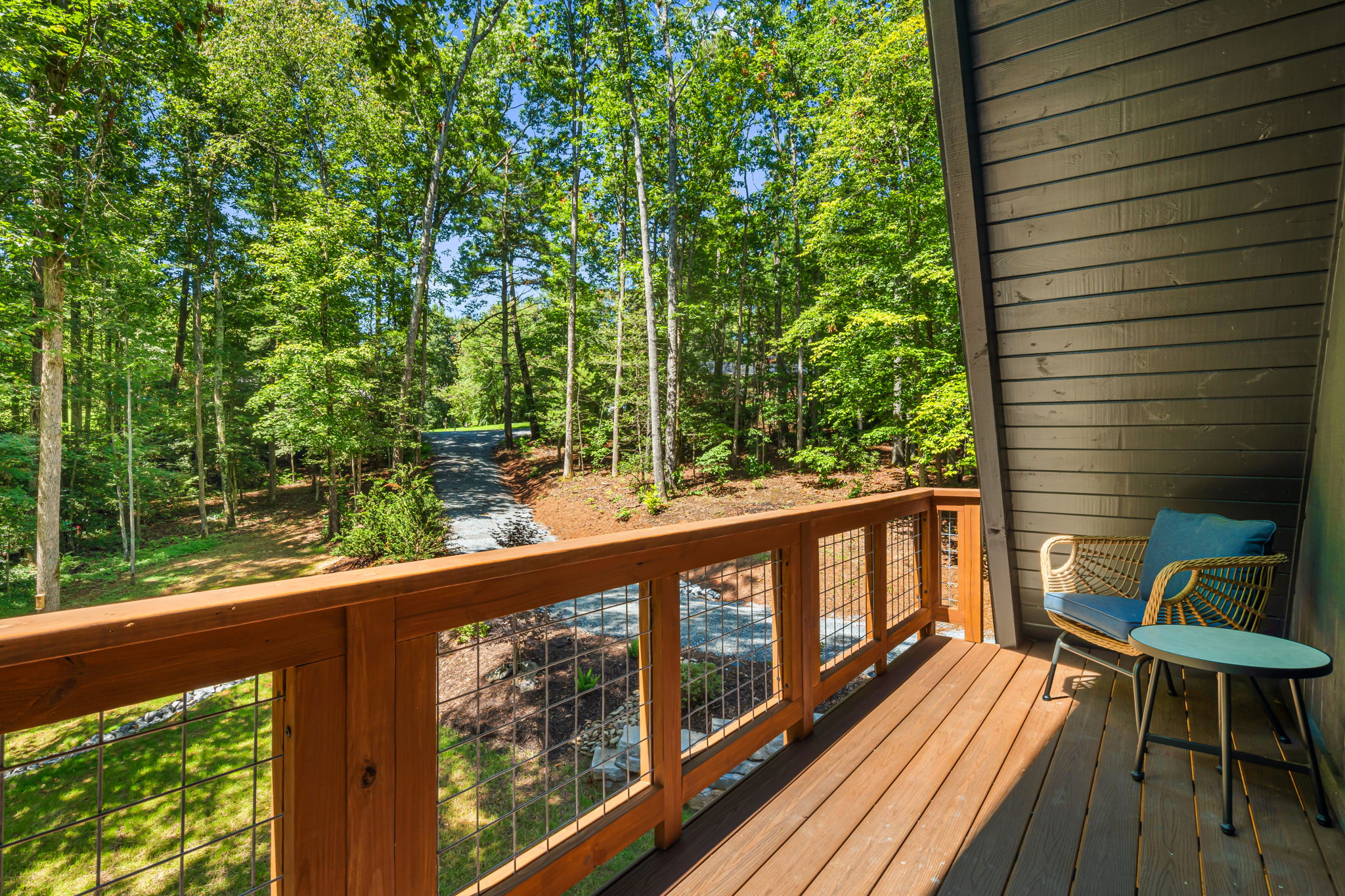 This exclusive balcony is off the main bedroom on the second floor. Accessible through french doors and with comfortable wicker chairs with cushions, perfect for enjoying morning coffee overlooking the front yard.