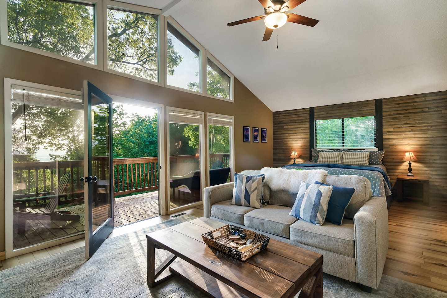The private master bedroom suite features its own living area, private bathroom, stone fireplace, vaulted ceiling, and a private deck.