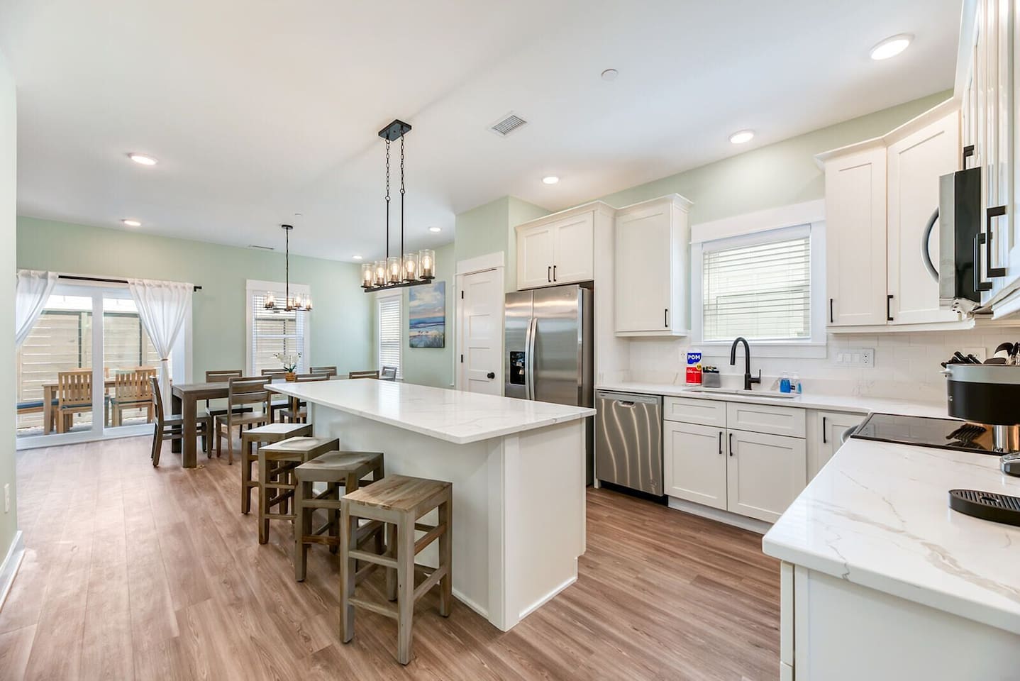 Fully stocked kitchen with modern appliances, ample counter space, and a large island perfect for meals and conversation.