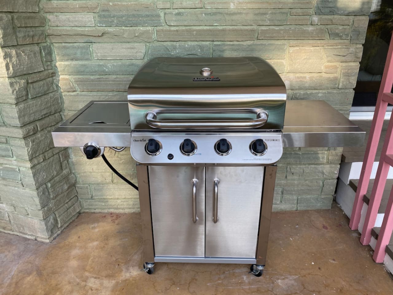 Gas grill located near the pool.