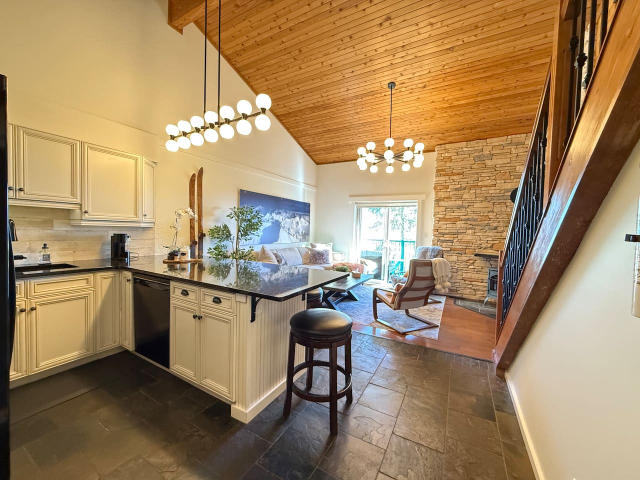 Modern Kitchen: An open-concept kitchen equipped with full-size Whirlpool appliances and a quiet Bosch dishwasher for a seamless cooking experience in your mountain getaway.