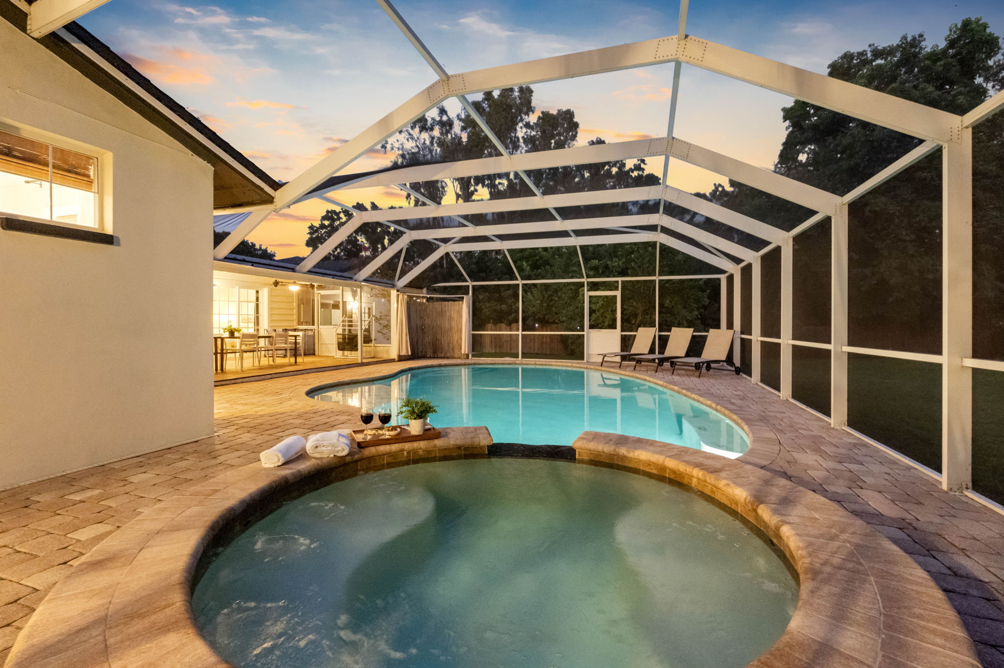 Evening ambiance with pool lighting creates a perfect space for night swims.