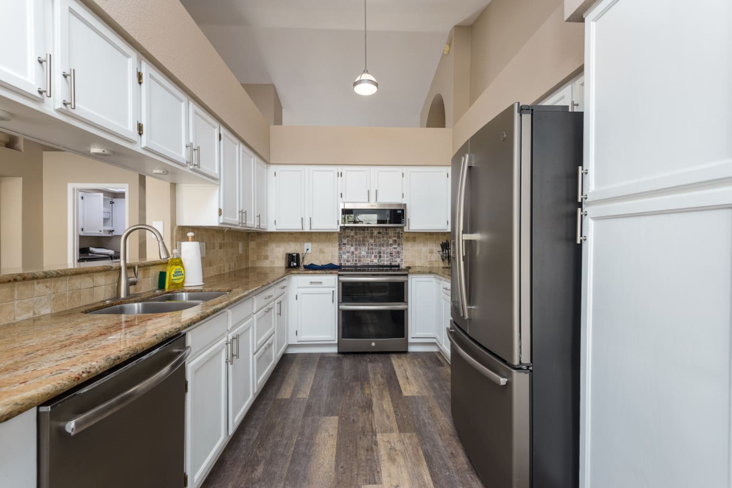 Full kitchen with stainless steel appliances, granite counters, coffee station, and plenty of cabinet storage for everyday meals.