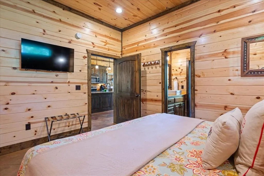 Downstairs bedroom with king bed and TV.