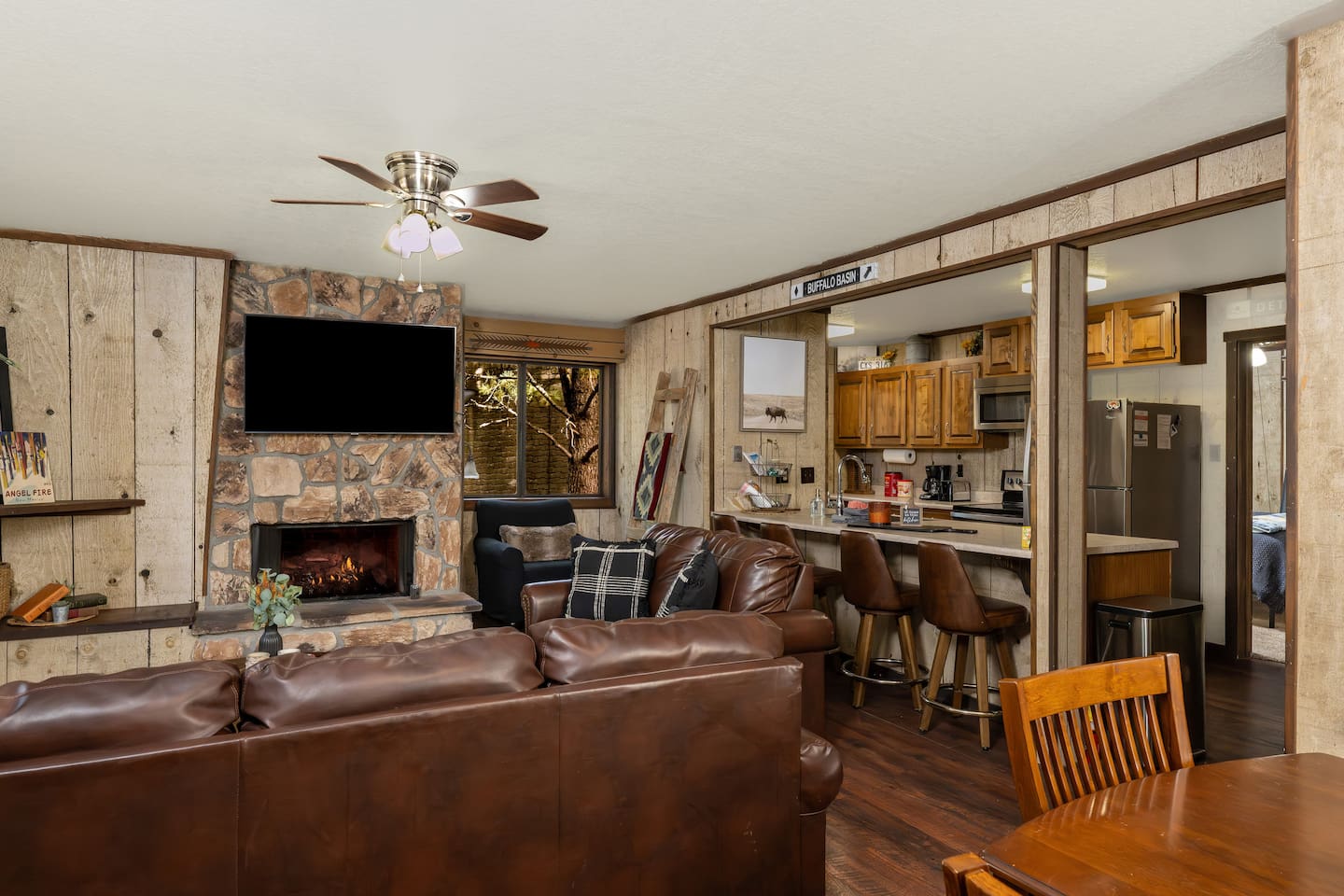 Cozy, open living room, dining room and kitchen with a fireplace.