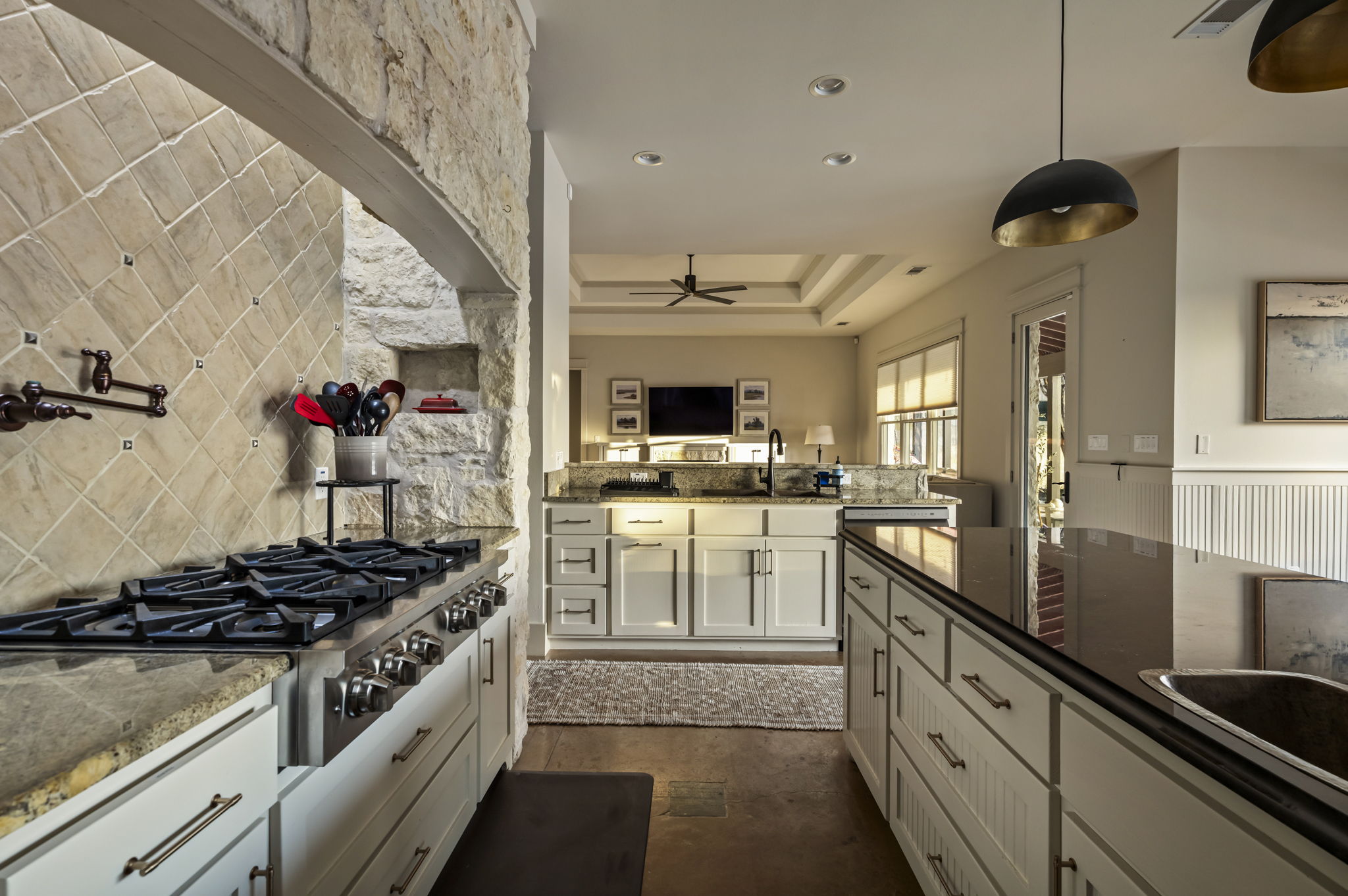A fully equipped kitchenette includes a fridge, stove, oven, microwave, sink, and utensils for convenient cooking.