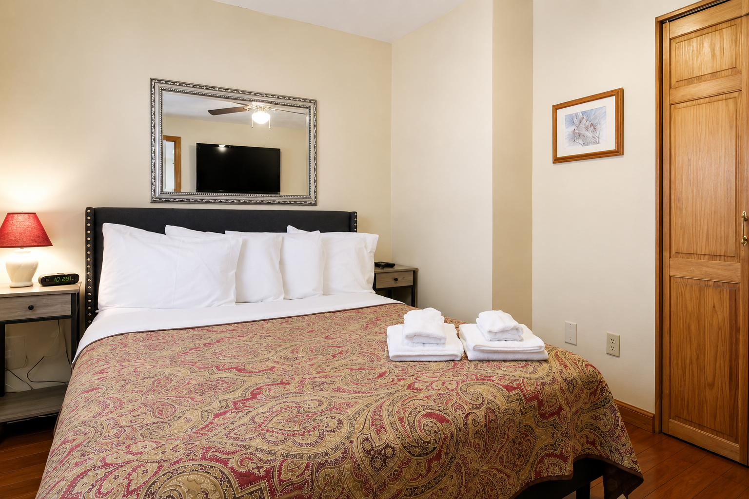 Bedroom with queen bed and hardwood floors