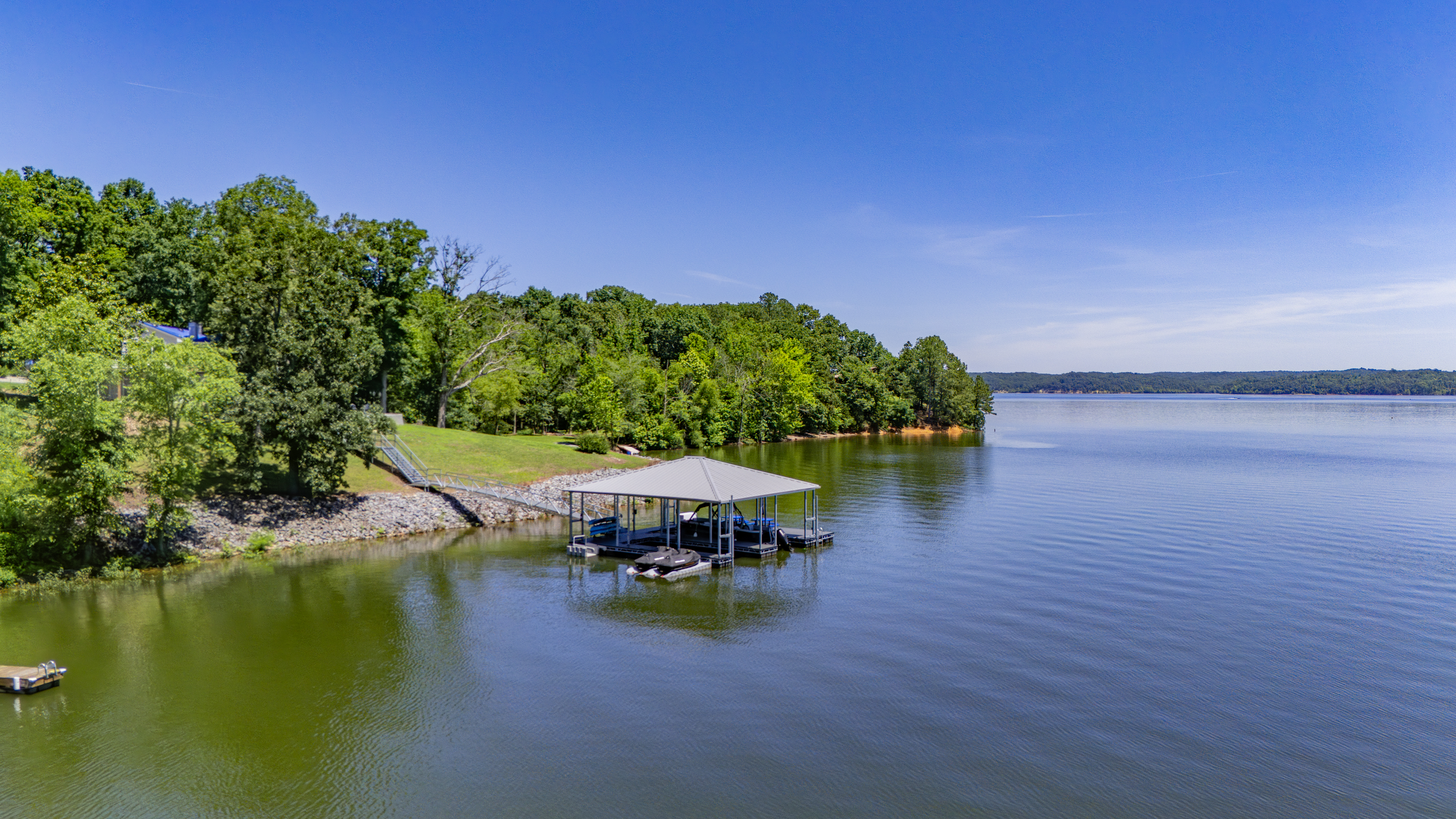 A wide drone view highlights the private covered dock and The View’s open-water location on Kentucky Lake.