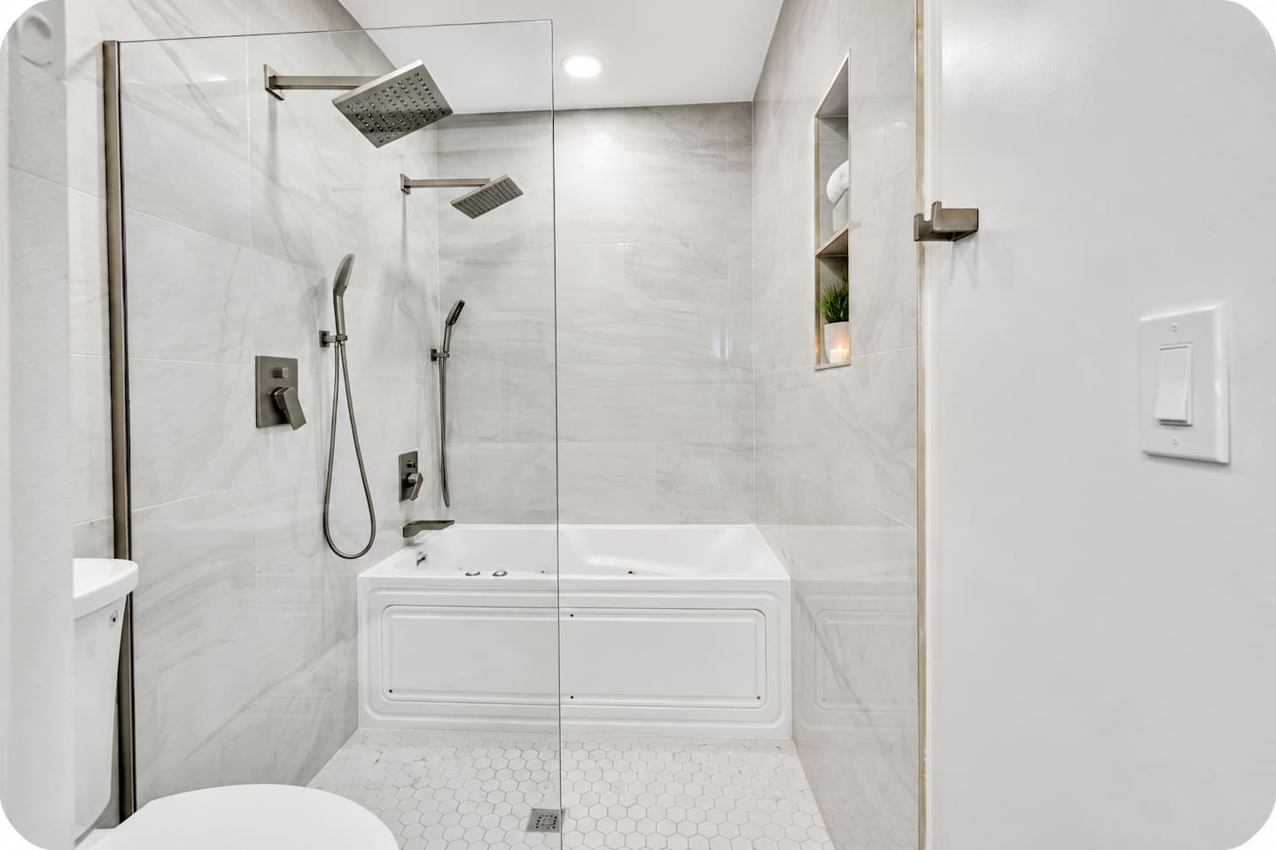 Spa-style full bathroom with a jetted tub, rainfall shower and handheld showerhead.