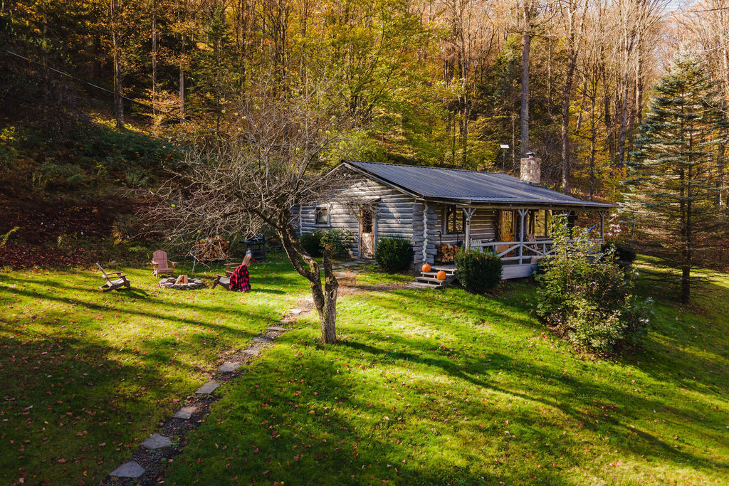 Escape to your private log cabin retreat, surrounded by woods with a cozy fire pit and plenty of space to relax under the trees.