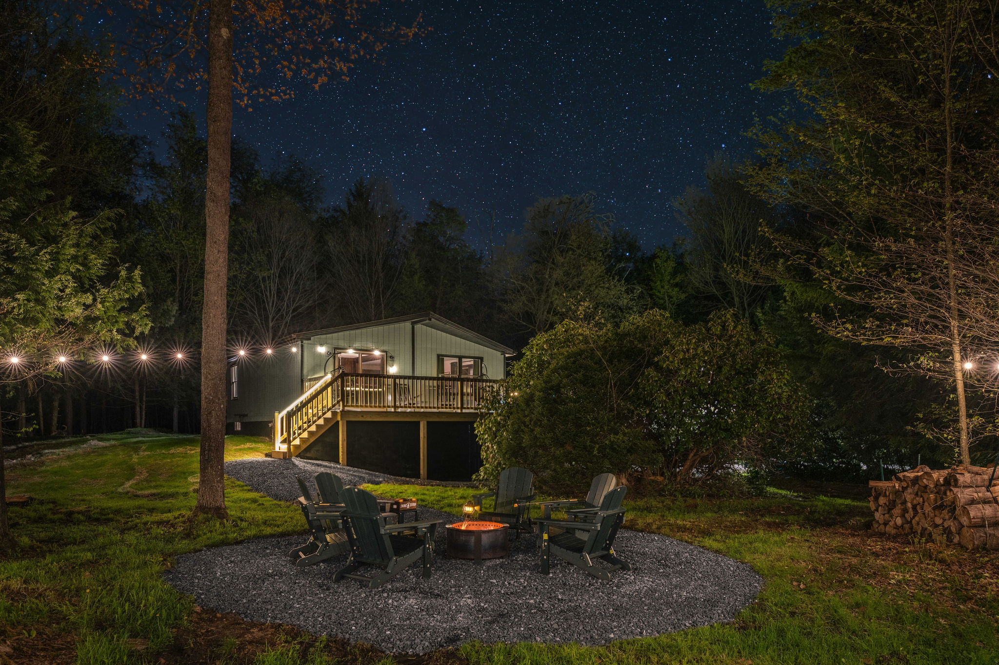🔥 Gather around the firepit under string lights as the forest goes quiet.