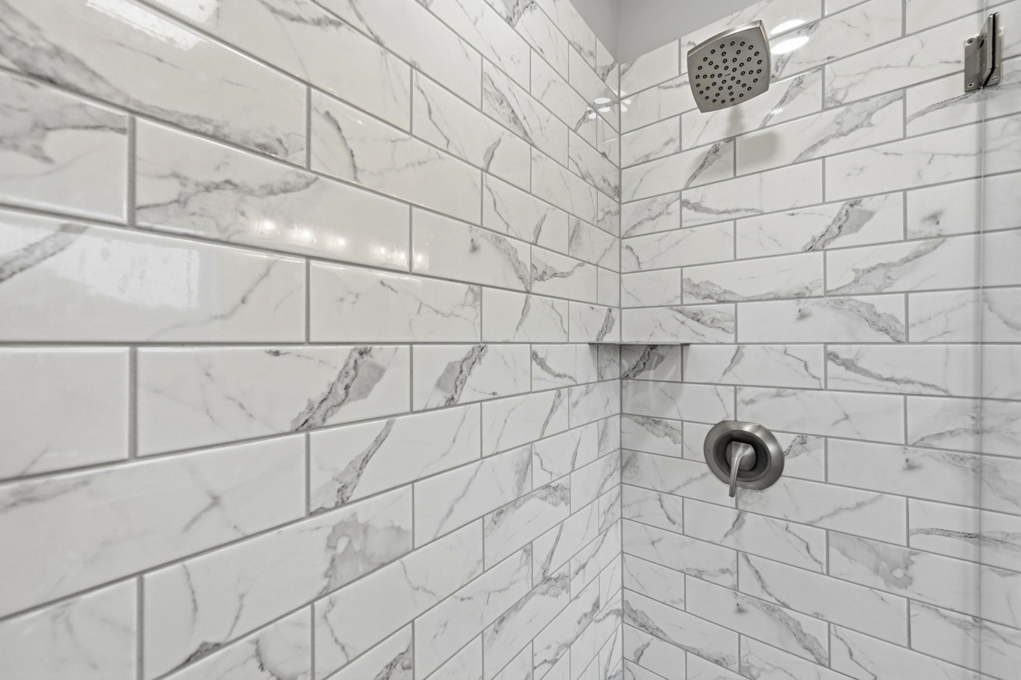 This ensuite bathroom features a sleek and refreshing shower - a perfect way to end a fun-filled beach day