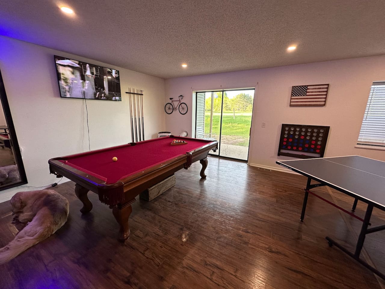 Spacious shared game room with pool table, ping pong, Connect 4, TV, board games and casual seating—perfect for relaxing or friendly competition after a day of adventure. Great for groups and families looking for fun during their stay!