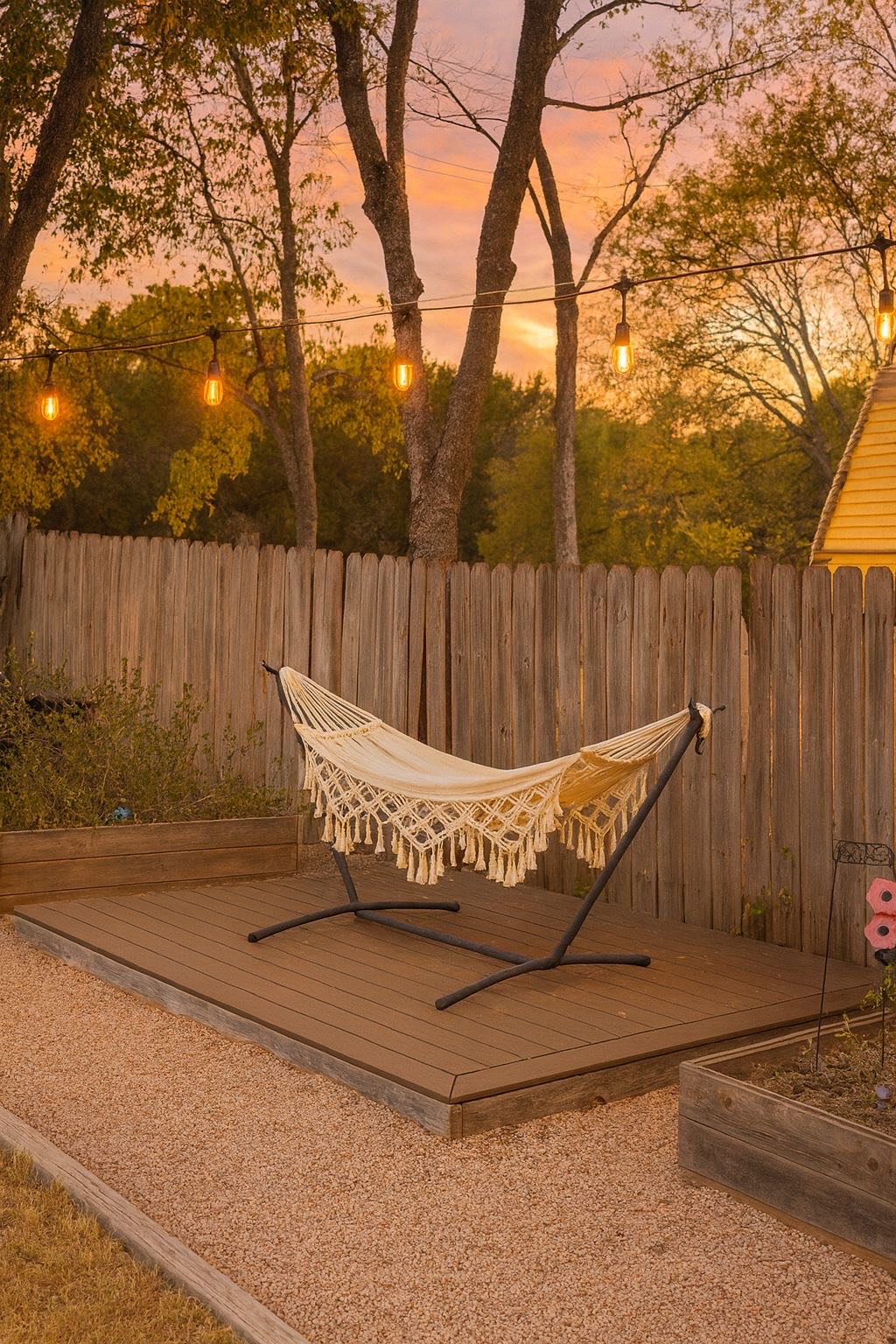 spacious back yard connects to the kitchen: hammock, covered patio with chairs, fire place.