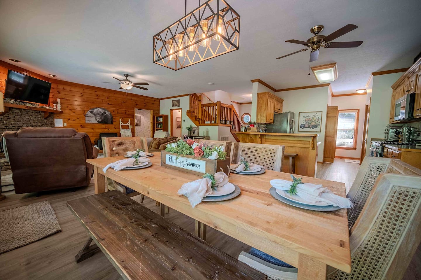 The heart of the home features a spacious dining area and fully equipped kitchen with bar seating—perfect for family meals, holiday feasts, or lazy morning breakfasts. With large windows that bring in the natural light and charming touches throughou
