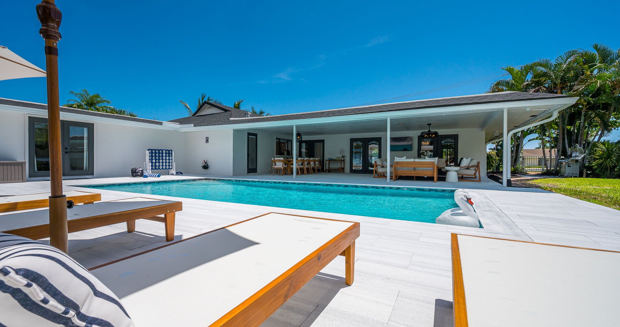 Spend your days lounging by the shimmering pool, dining al fresco under the covered patio, and unwinding in stylish outdoor living spaces—all set against a serene lakefront backdrop with private dock access