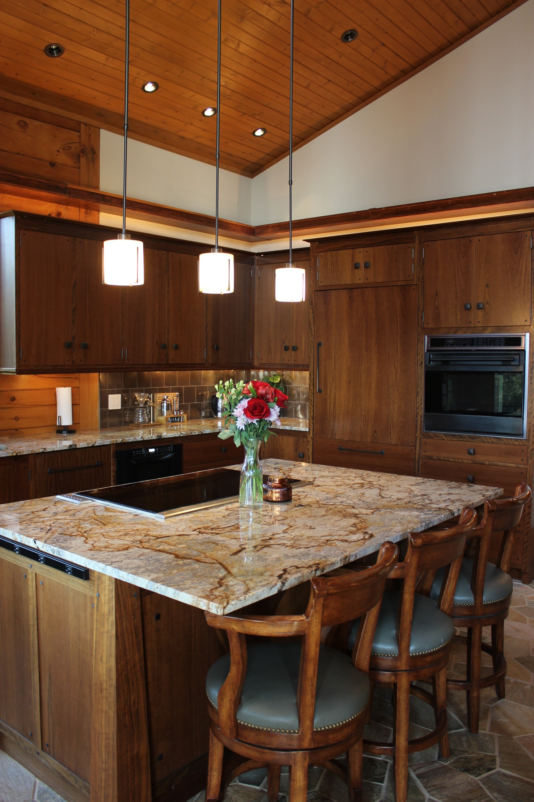 Large kitchen island with stove and 3 bar stools