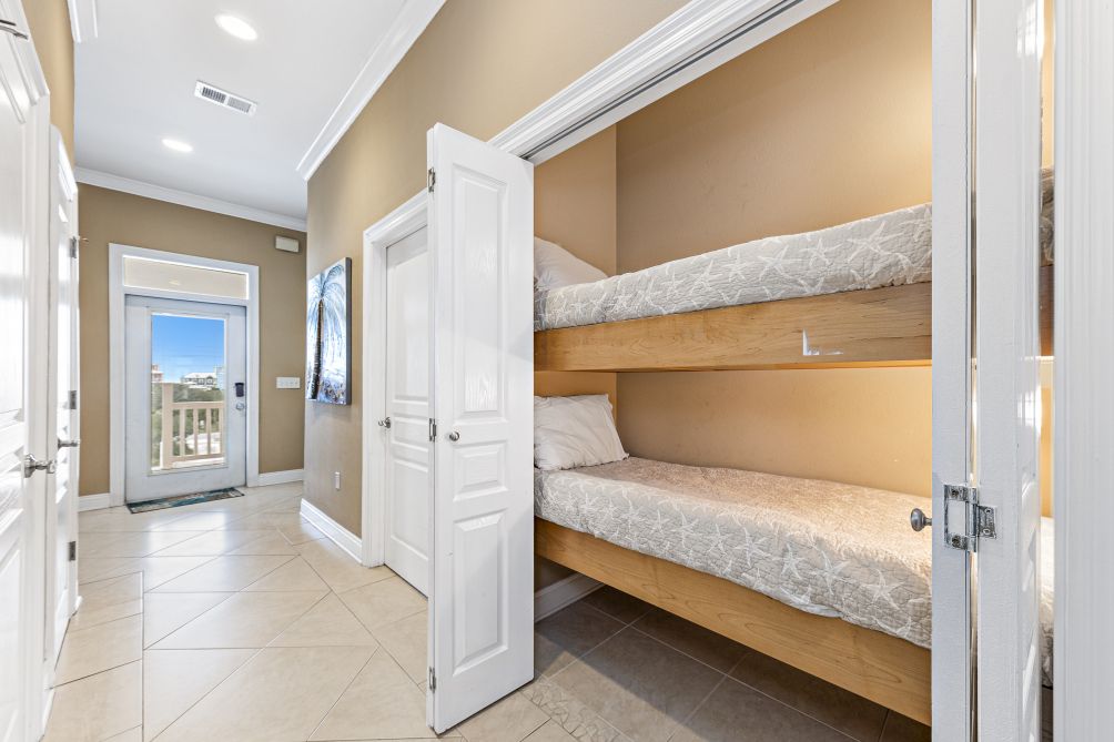 Hallway with built-in bunk beds leading to a private balcony