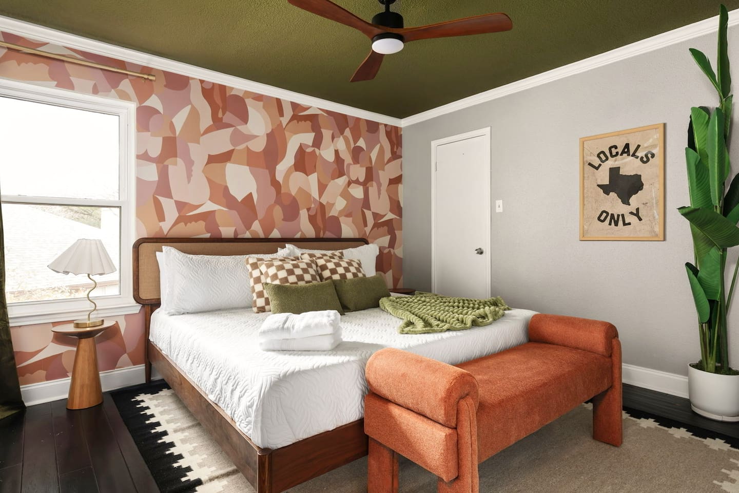 Charming bedroom with plush bedding, accent seating, and vibrant design—ideal for a comfortable and relaxing stay