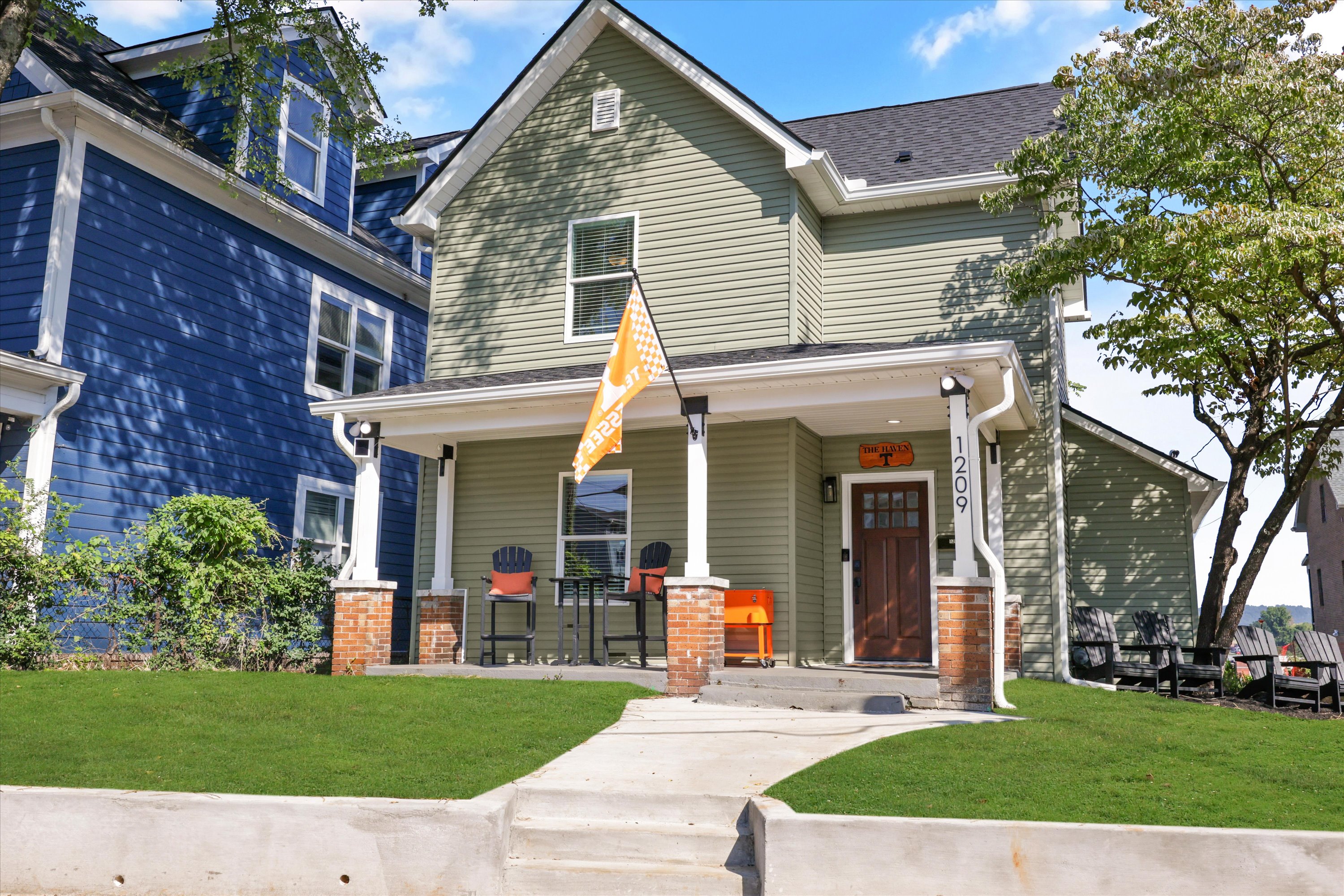 Covered front porch perfect for coffee, drinks, and tailgating