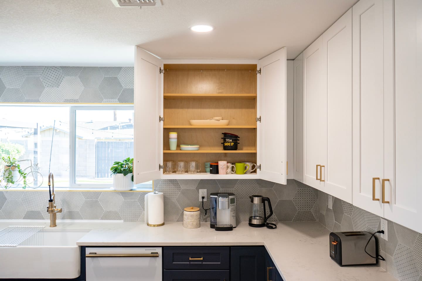 Thoughtfully stocked kitchen with mugs, glassware, and essentials—everything you need for coffee, meals, and easy stays in Scottsdale