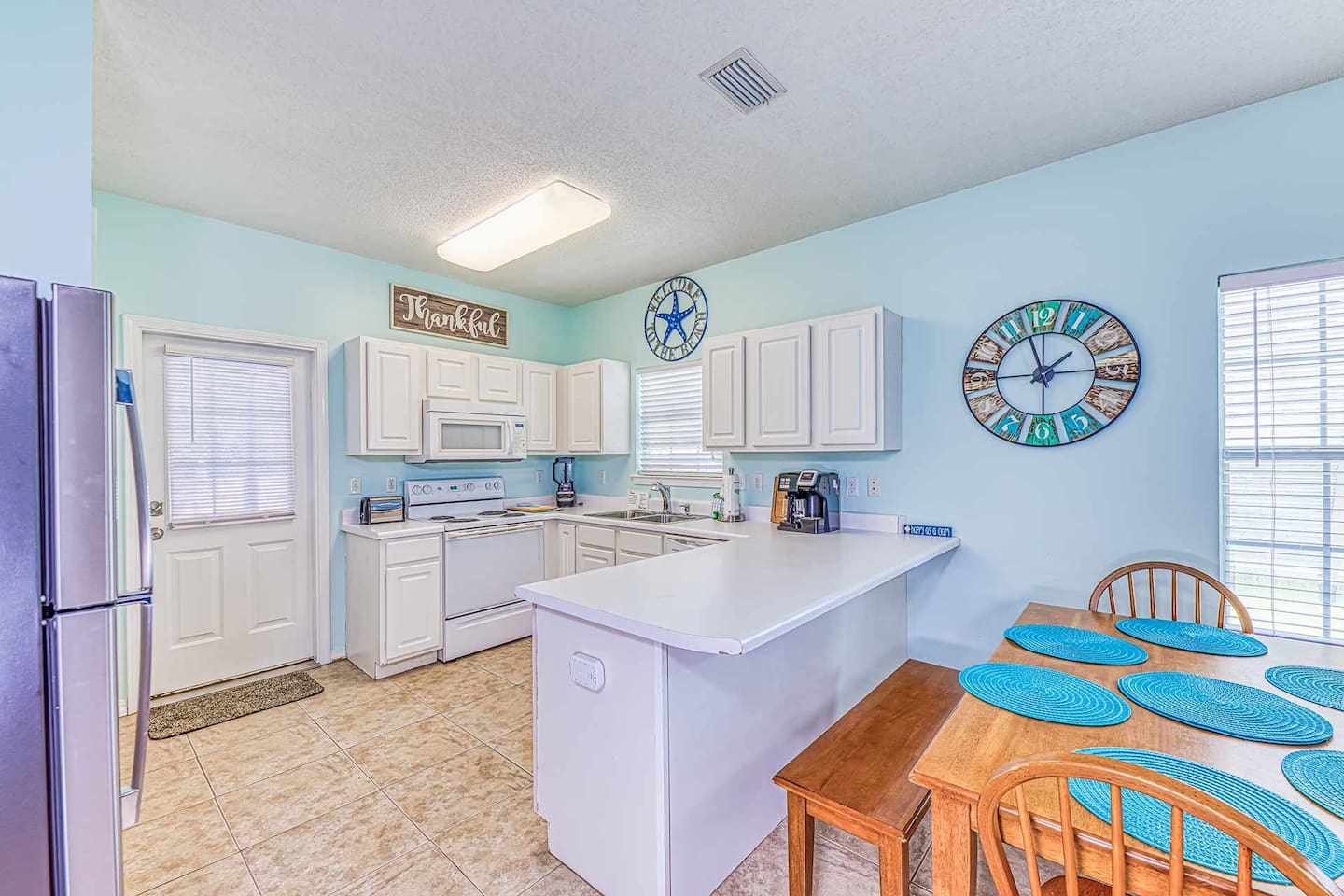 Kitchen: Bright and airy space with modern appliances and a cheerful coastal vibe!