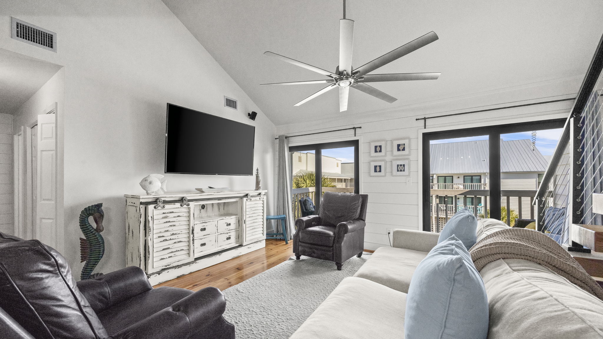 Enjoy the updated living room in our Cotton Bayou condo, featuring stylish coastal decor, a smart TV, and comfortable seating. The perfect space to unwind and relax after a day at the pool or on the wate