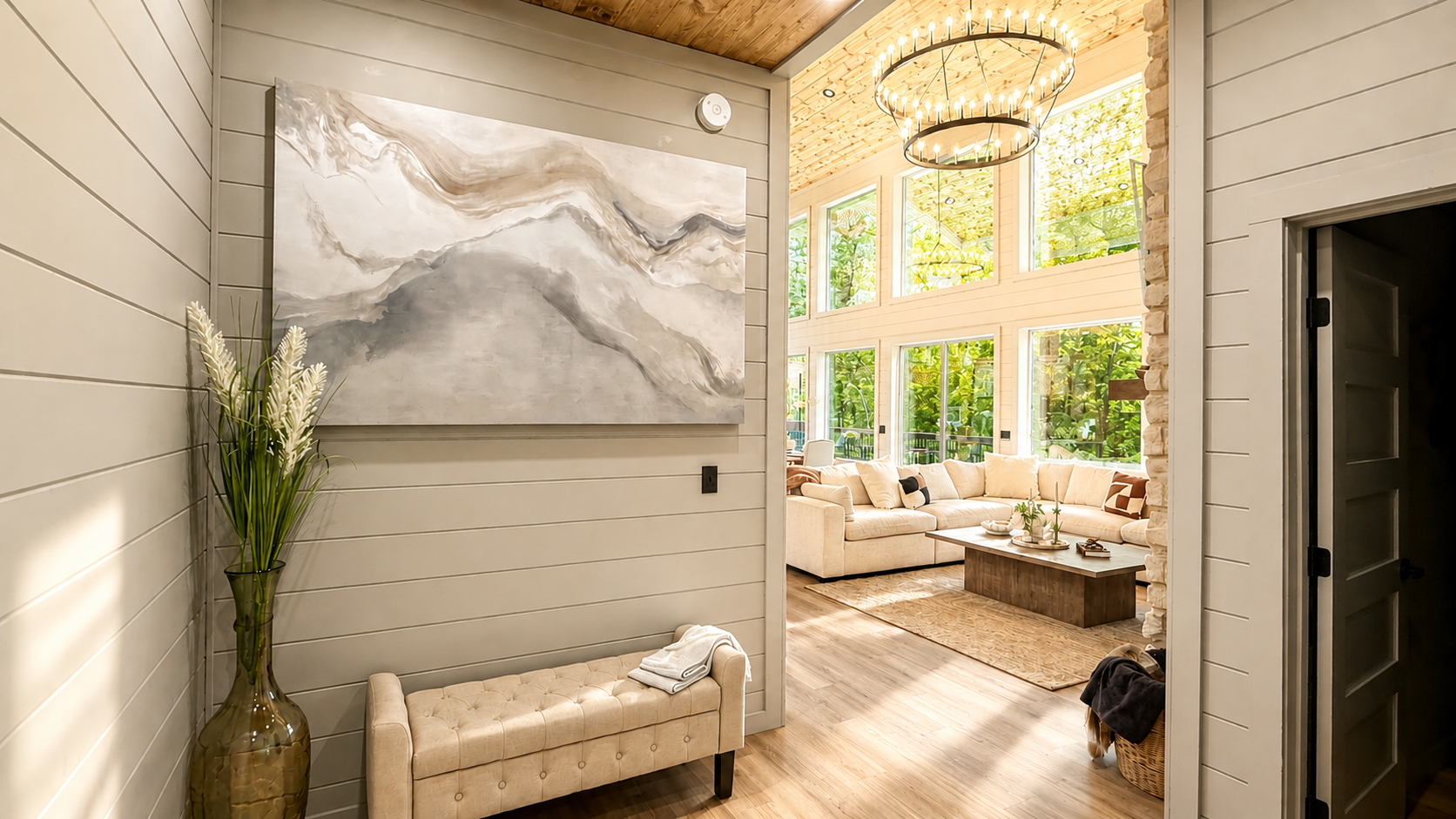 Living Room: Sunlit space with large windows, plush seating, and a stylish art piece awaits you!